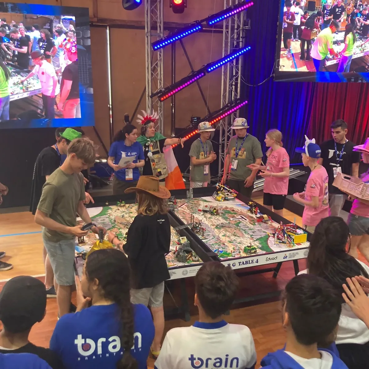 Both teams gathered around the robot game table during the Alliance Cup